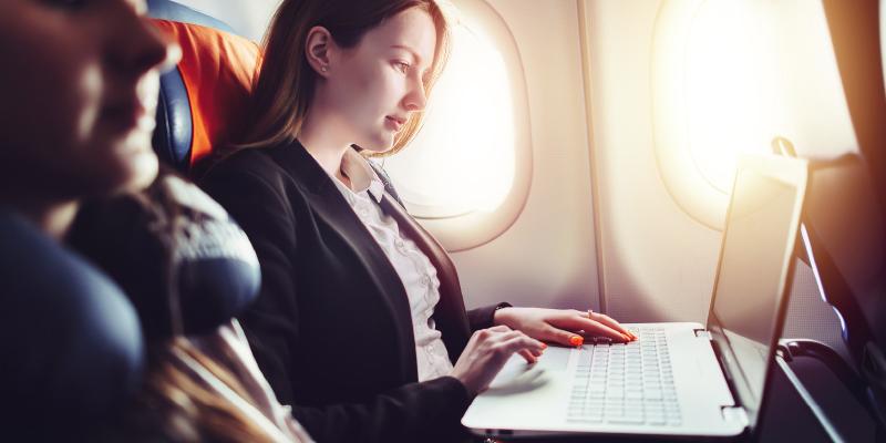 Girl on plane with laptop